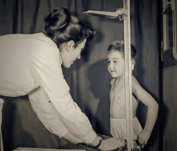 doctor in front of a child in the 60s